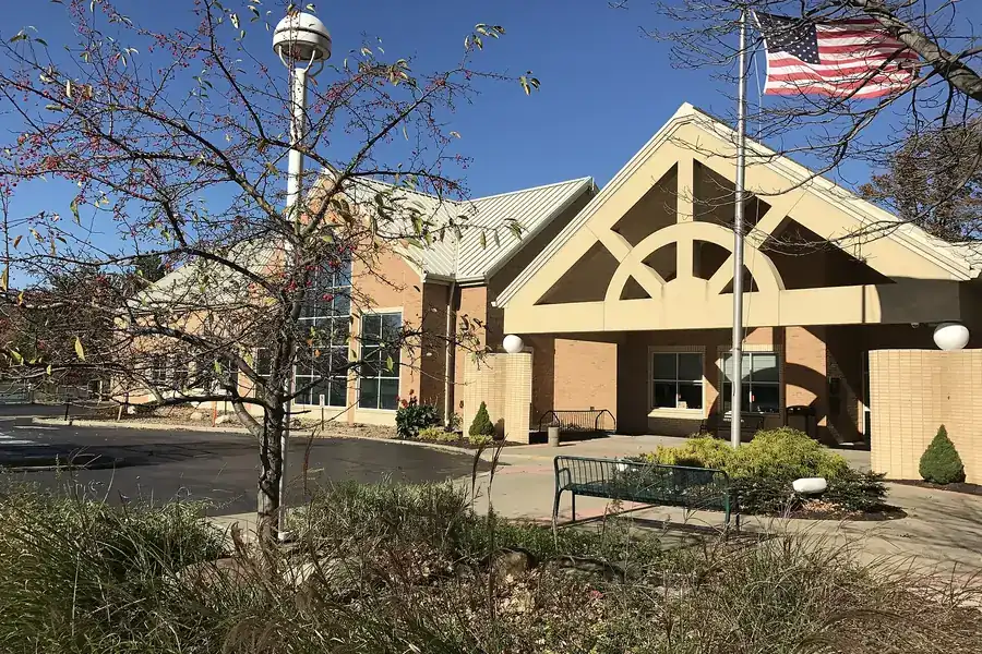 The Avon Lake Public Library entrance with a flagpole and landscaping in Avon Lake, Ohio
