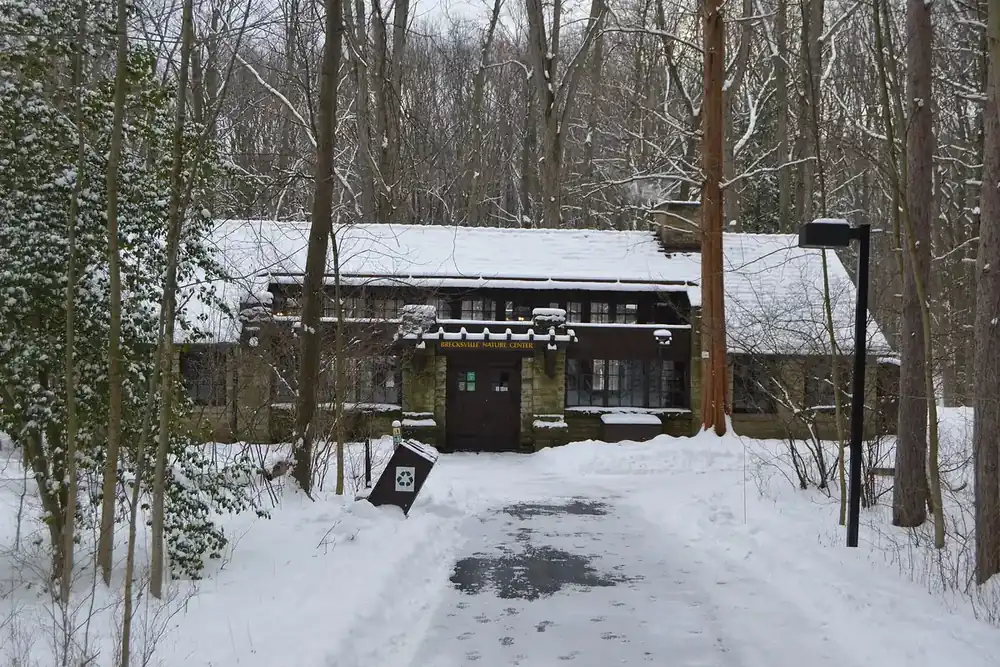 A snowy path leading to the stone Trailside Museum in the Brecksville Reservation, Ohio