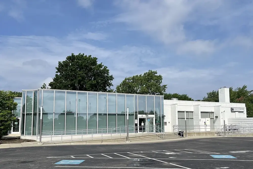 Glass-fronted public building with a parking lot in Brook Park