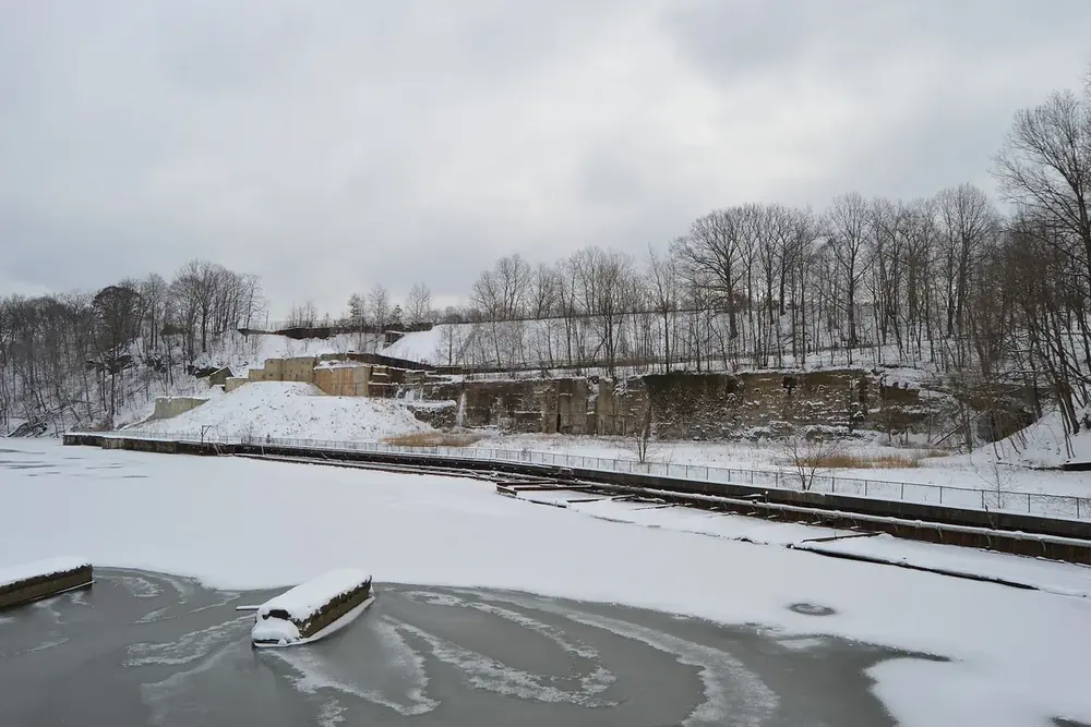 A snowy view of the frozen Cuyahoga River from the Front Street bridge in Cuyahoga Falls, Ohio