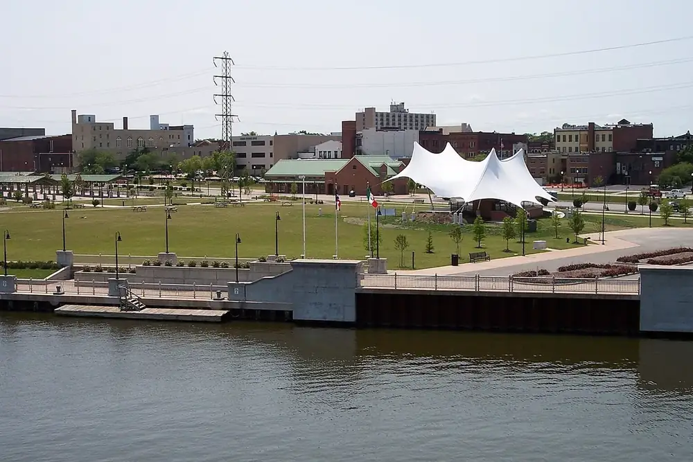 The Black River waterfront park and downtown Lorain, Ohio buildings on a summer day