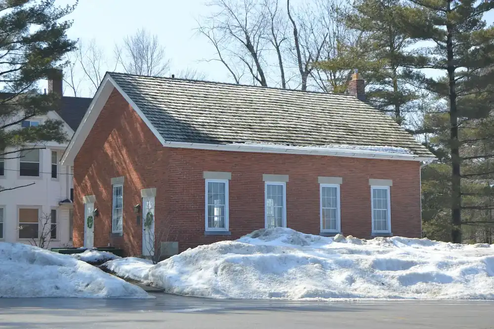 The old red brick Euclid District 4 schoolhouse with snow banks in Lyndhurst, Ohio