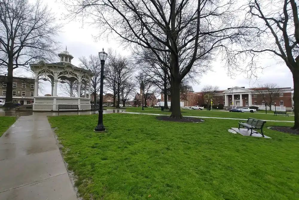 A white gazebo and old trees in Uptown Park on the square in Medina, Ohio