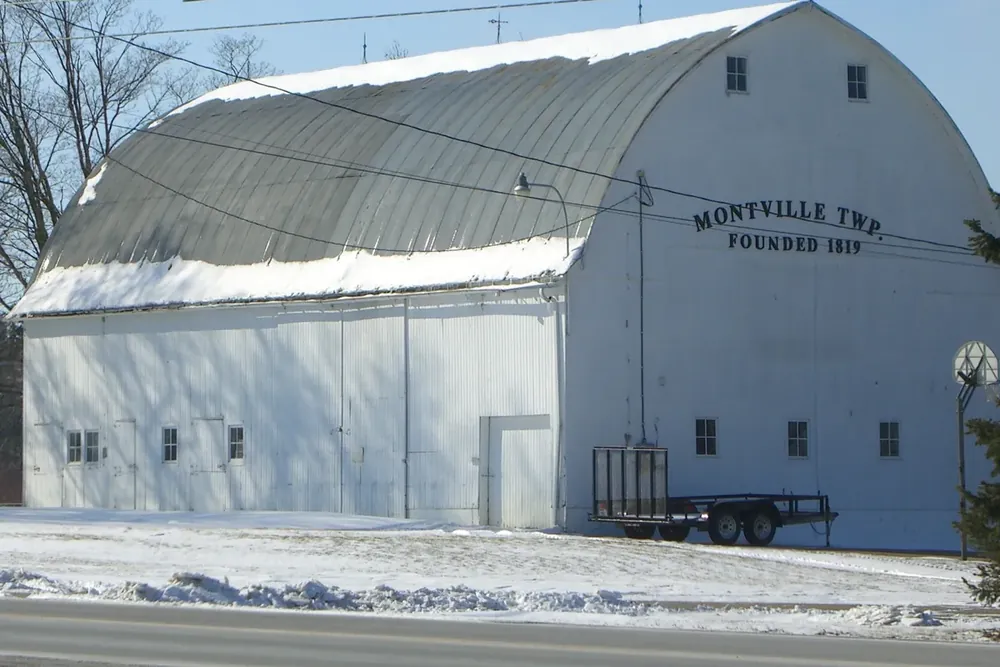 The white arched-roof Montville Township barn with snow on the ground in Medina County, Ohio
