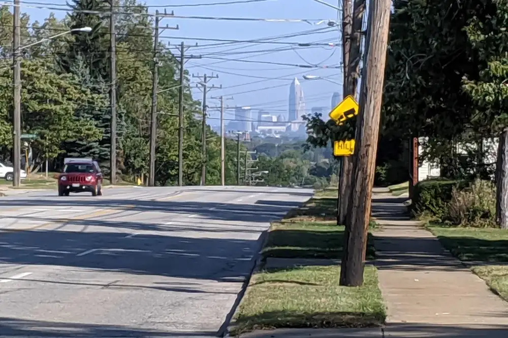 A tree-lined Parma street with the Cleveland skyline in the distance, Parma, Ohio