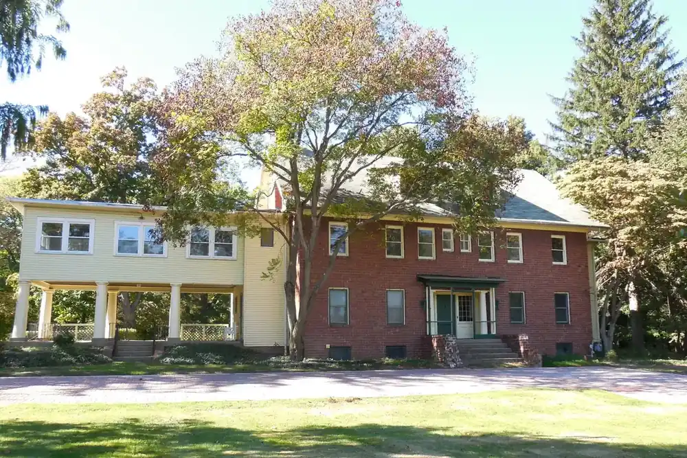 The large main house at Greenwood Farm under autumn trees in Richmond Heights, Ohio