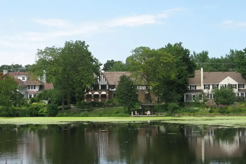 Large historic houses among trees beside a calm lake in Shaker Heights, Ohio